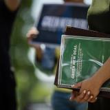 Picture of Congresswoman's holding the Green New Deal implementation guide