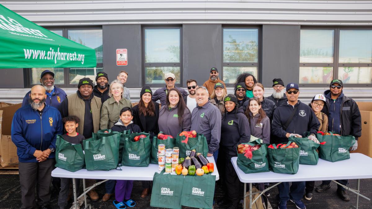 Rep. AOC and City Harvest Staff and Volunteers Take a Picture at Their Food Distribution