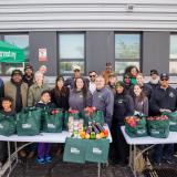 Rep. AOC and City Harvest Staff and Volunteers Take a Picture at Their Food Distribution